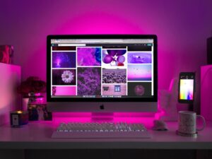 A glowing desktop display featuring purple-themed website elements, highlighting creative design and immersive web aesthetics.