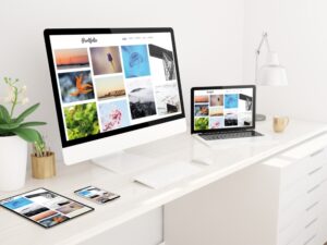 Modern architect portfolio website displayed on desktop, laptop, tablet, and smartphone in a minimalist white workspace.
