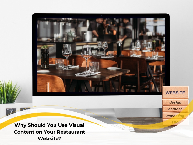 A desktop computer shows a softly focused image of a restaurant dining area with set tables and staff in the background, illustrating the point of using visual content on your restaurant website. Stacked wooden blocks beside the monitor highlight key aspects of a website: design, content, marketing, and SEO.