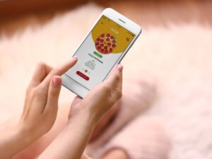 Ordering pizza online through a mobile app with a clear truck food menu layout.