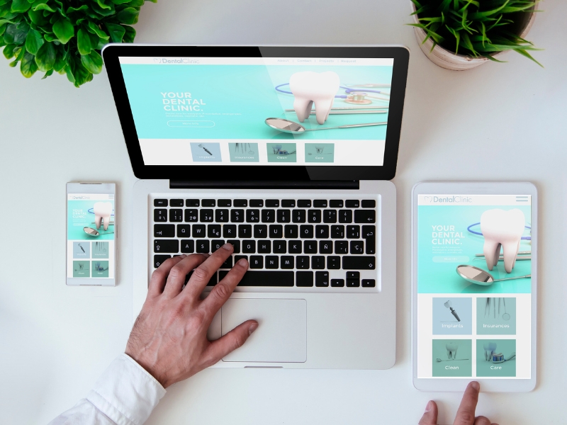 User interacting with dental website templates on laptop, tablet, and smartphone with modern responsive design