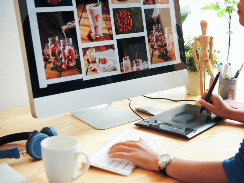 Designer creating food gallery layout for good restaurant website design on desktop screen