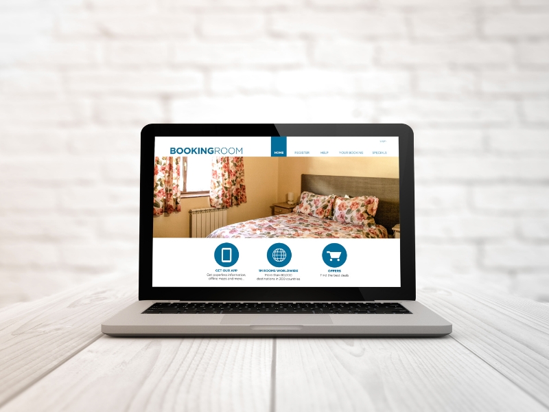 Laptop on a white desk displaying a hotel booking homepage, showing clear navigation and effective websites ideas in action.